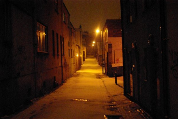 Colour photograph of Hampton Lane at night with fresh snow and amber street lighting